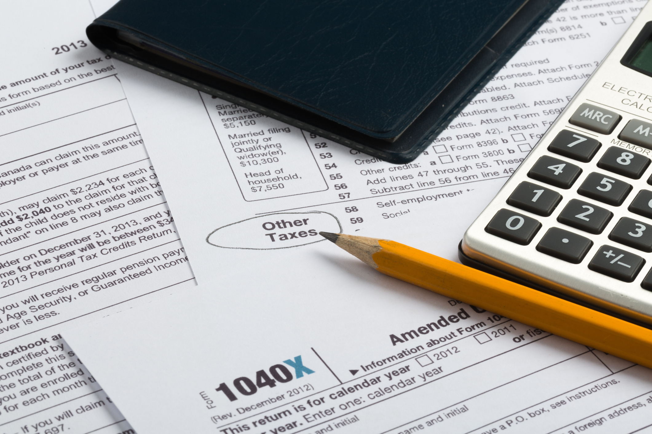 Tax Documents with Calculator and Pencil